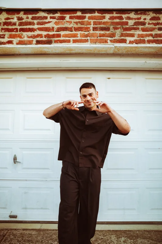 Andrew Weiss in front of a garage door