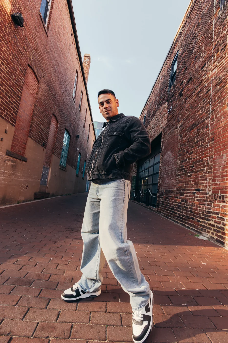 Andrew Weiss standing in a brick-lined Washington, DC alley